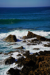 waves crashing on rocks at the Rota Vicentina in the south of Portugal at the coast 