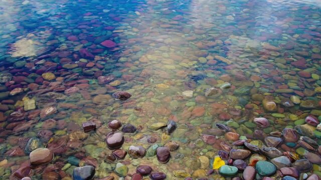 Multi Colored Stones Seen Through The Clear Water of Lake McDonald, Glacier National Park, Montana, USA