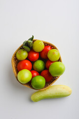 Raw vegetable in wooden bowl on white background.