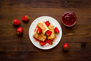 Hot french crepes with strawberry and berry sauce. Sweet dessert