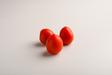 Fresh red tomato on white background.