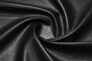 black artificial leather with waves and folds on PVC base