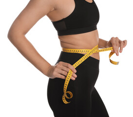 Woman measuring waist with tape on white background, closeup