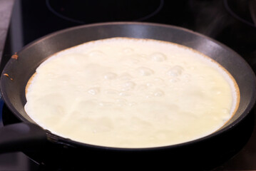 Making homemade pancakes. the dough in a frying pan. close up