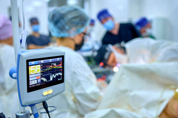 surgeon in the operating room performs an operation on a patient