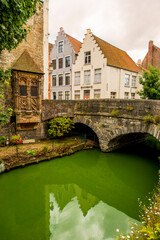 Medieval stone bridge on canal, on canal, Bruges, West Flanders, Belgium.