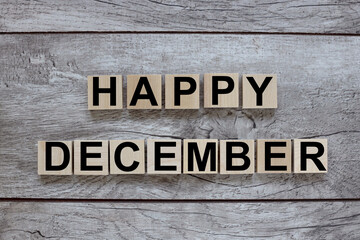 HAPPY DECEMBER. wooden cubes on a wooden background. three wood blocks
