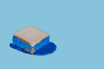 Abstract toast bread with a special glitter spread on a blue background.