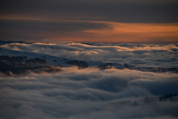 Wonderful aerial view of picturesque scene of sky and white clouds and winter mountain landscape