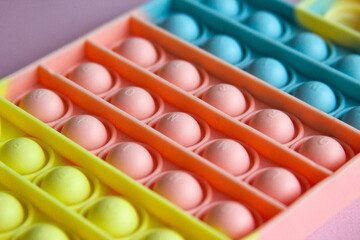 Pop it sensory toy from soft silicone bubbles. Stress and anxiety relief. Trendy game for stressed children and adults.