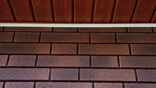 Close-up Of The Wall Of The House From Red Flexible Facade Panel Imitation Of Clinker. Moving Camera