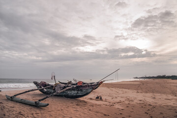 Old Fishing boats on empty beach in Sri Lanka