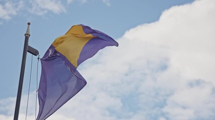 National flag of Bosnia and Herzegovina waving in the wind against beautiful sky. 