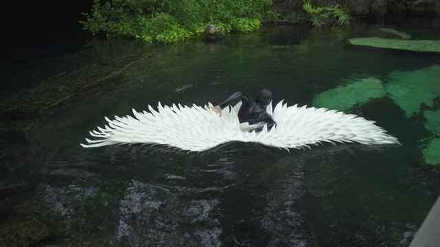 woman in wetsuit, diver cannot submerge an angel wing suit. High quality 4k footage
