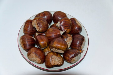 Fresh chestnut fruits in dish on white background, Sofia, Bulgaria  