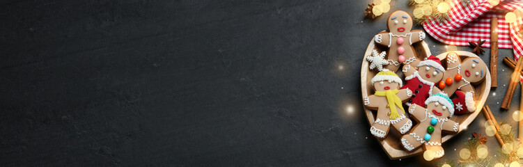Flat lay composition with delicious Christmas cookies on black table, space for text. Horizontal banner design