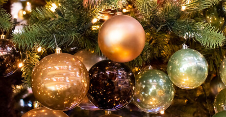 Obraz na płótnie Canvas Festive Christmas tree toys and the lights. 2022 holiday concept
