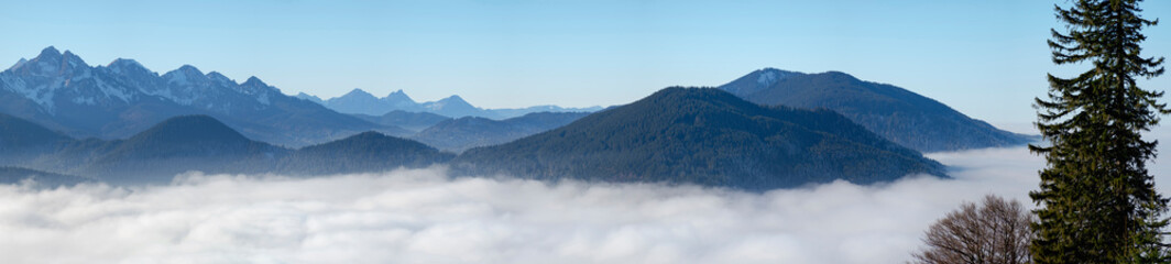 View from Mount Hoernle over a sea of fog hiding the valley of river Ammer towards Fuessen....