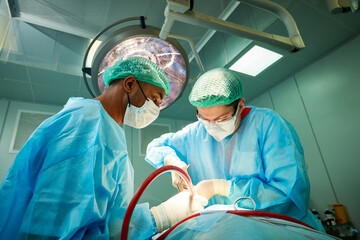 Emergency surgery. Surgeons during surgical intervention in clinic