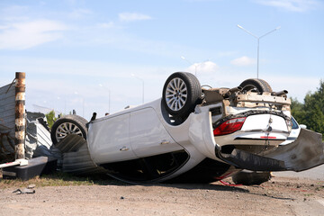 A car overturned on the body as a result of an accident on the road. Selective focus.