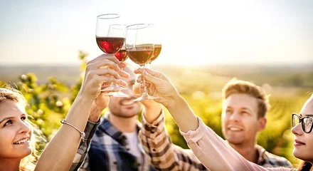 Foto op Plexiglas Happy people enjoying harvest time together at farmhouse winery countryside - Youth and friendship concept - Toasting red wine glass at vineyard before sunset - Focus on the wine glass © napeter