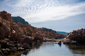 Naklejka premium Beautiful stone coast splashed by seawater. Look on an open sea.