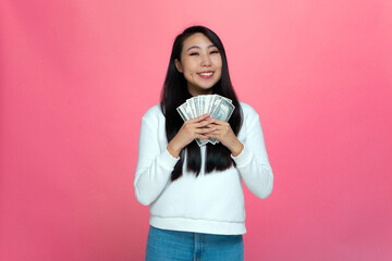 Happy rich young asian girl holding cash banknotes, enjoy money win, big financial profit and...