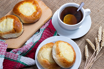 Sweet buns with cottage cheese and a cup of hot tea