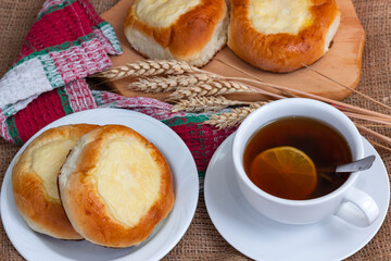 Sweet buns with cottage cheese and a cup of hot tea