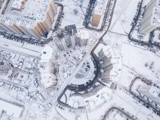 Overhead view of round high rise buildings construction site in winter