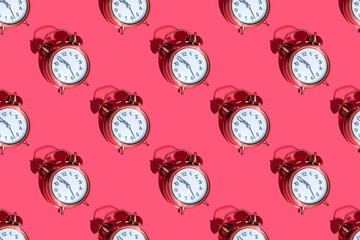 Alarm clock on a colored background hard shadows. Close up. Seamless patterns