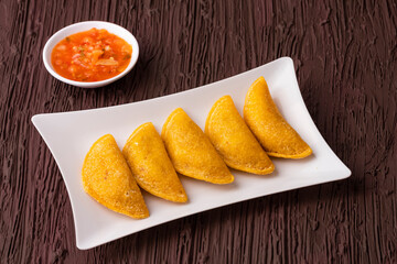 Fried empanadas with spicy sauce - Typical Colombian food