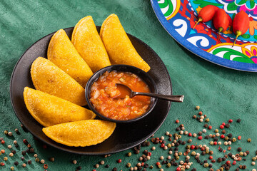 Delicious and traditional Colombian empanadas with spicy sauce
