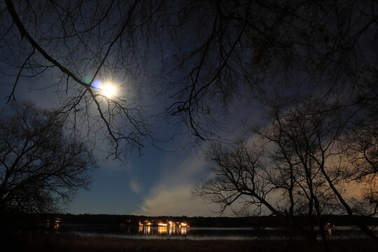 Autumn night photo. Great nature at the Swedish countryside. Shiny moon and some clouds. Long exposure shot. Close to a lake. Stockholm, Sweden, Scandinavia, Europe.
