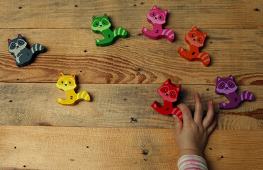 Preschooler learning to count playing wooden figures toy with numbers. Concept of preschool...