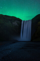 Northern Lights above the Famous waterfall of Skogafoss in Iceland.