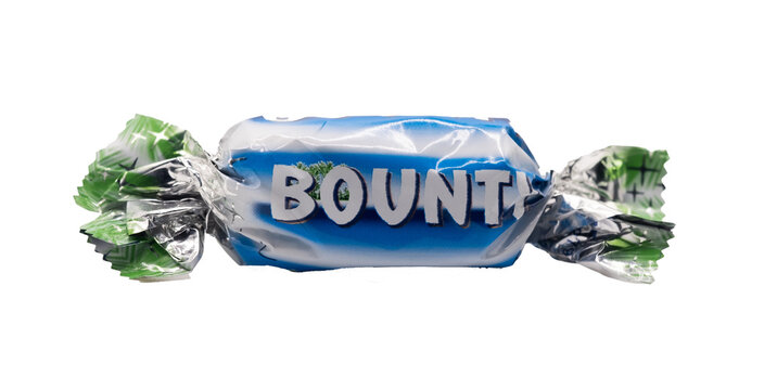 Norwich, Norfolk, UK – December 2021. Close And Selective Focus On A Funsize Bounty Chocolate Bar From A Tub Of Mars Celebrations. Cut Out And Isolated On A Plain White Background