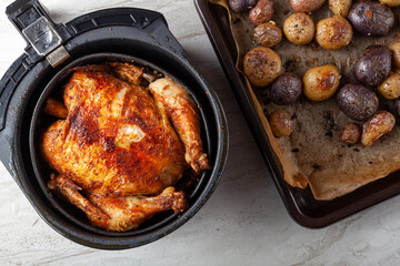 A whole chicken cooked inside an air frier concept. A healthy nutritious homemade alternative to...