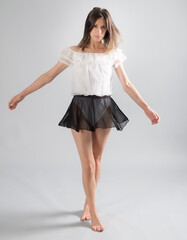 Woman in White Bodysuit and Sheer Black Skirt Dancing