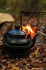 campfire in the forest teapot and bread