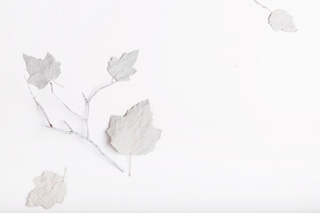 Minimalist Christmas composition in bright colors made of white dry leaves and berries on white background. Christmas, winter, new year concept.