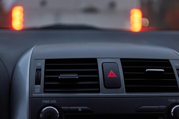 Obraz na płótnie Canvas Dashboard hazard light button in stopping traffic