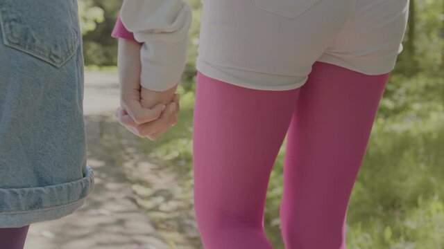 Two girls spend leisure time walking in the fresh air.