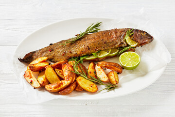 baked trout fish with roast potatoes, top view