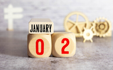 January 2nd.January 2 white wooden calendar on wood background.Copyspace for your text.Winter day.