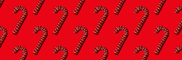 Christmas holiday pattern. Red canes on red background. Banner for website.