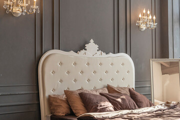 Luxury bed set with headboard and gray wall in bedroom