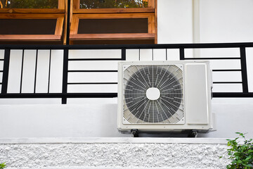 White one unit of conditioning ventilator installed on the wall of the  new building, soft and selective focus.