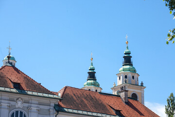 Fototapeta na wymiar Selective blur on the clocktower of the Ljubljana cathedral with its typical austro hungarian baroque architecture. Also called Katedrala Ljubljana, it's the main catholic landmark...