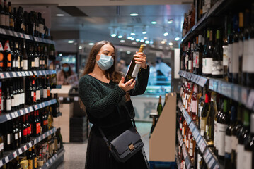 Female buying wine during pandemic